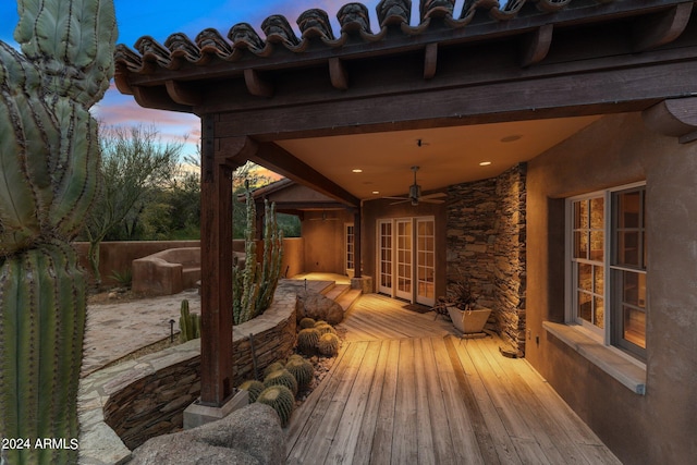 deck at dusk featuring french doors