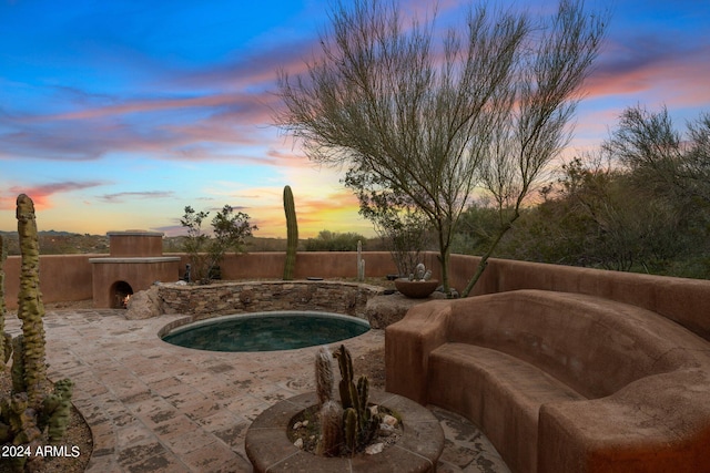 pool at dusk with a patio