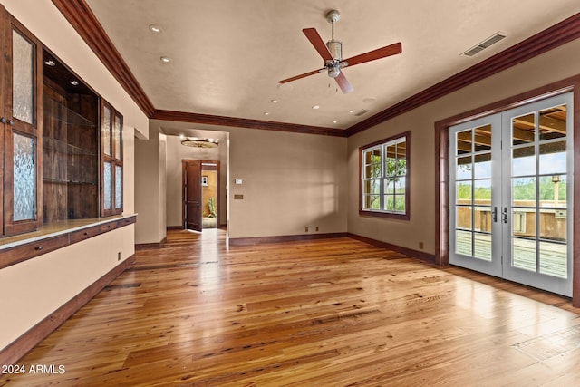 unfurnished room with ceiling fan, french doors, crown molding, and light wood-type flooring