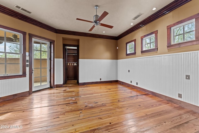 spare room with ceiling fan, ornamental molding, and light hardwood / wood-style floors