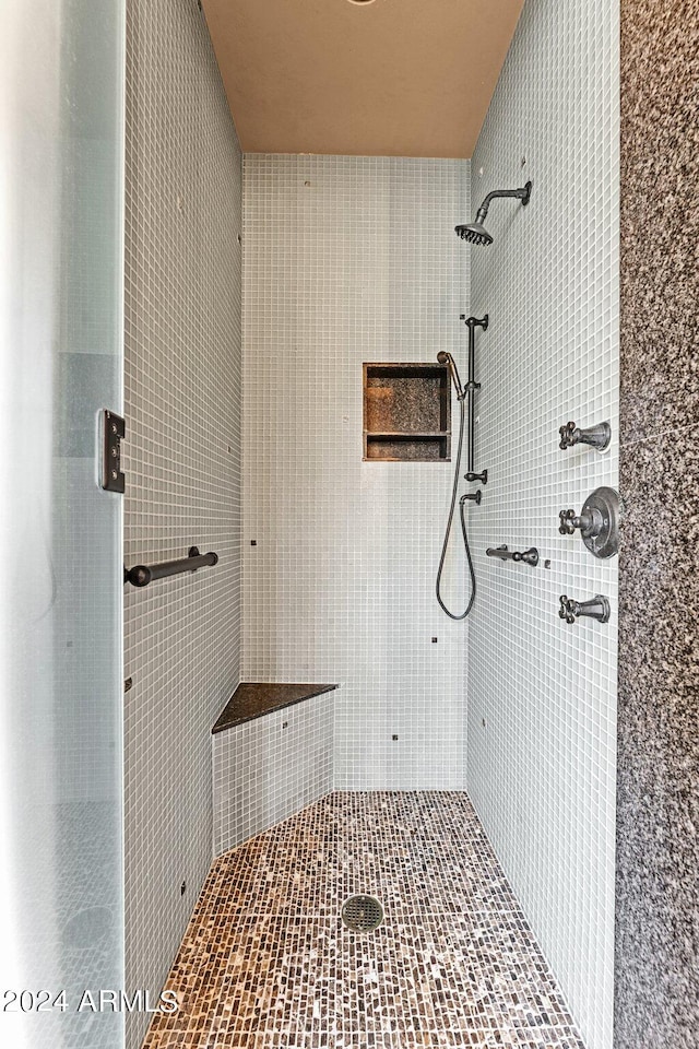 bathroom with tiled shower