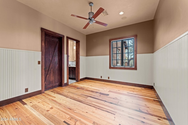 spare room featuring ceiling fan and light hardwood / wood-style flooring