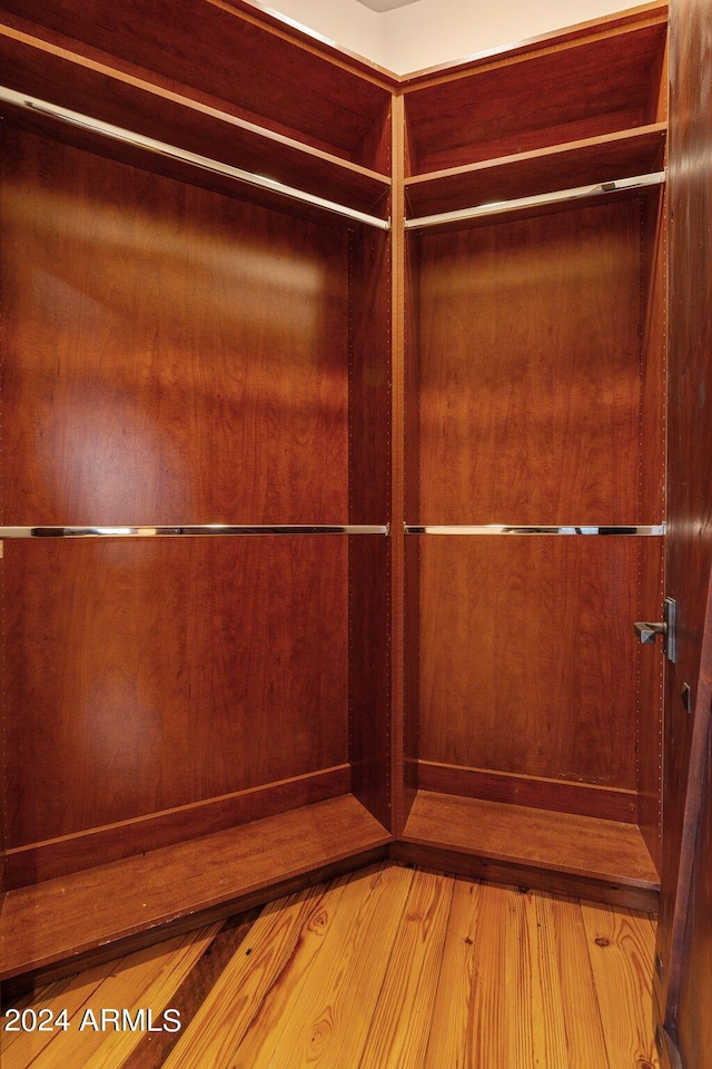 spacious closet with hardwood / wood-style flooring and elevator