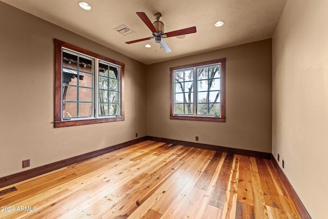 unfurnished room with ceiling fan and light hardwood / wood-style floors