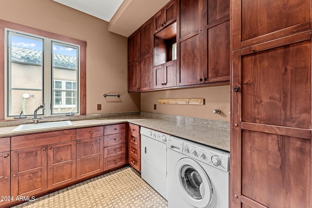 clothes washing area with cabinets, sink, washing machine and dryer, and light tile floors