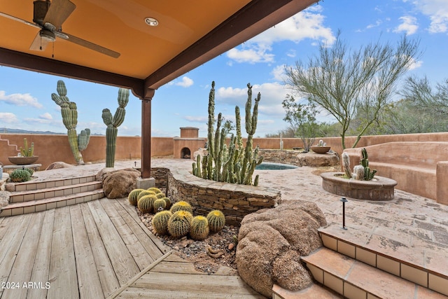 wooden deck with ceiling fan and a fenced in pool