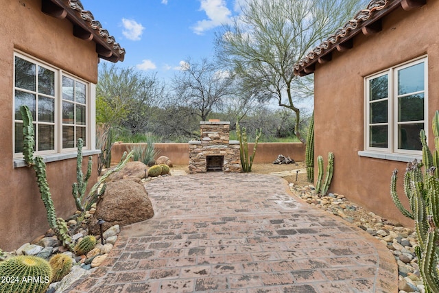 view of patio / terrace featuring an outdoor stone fireplace