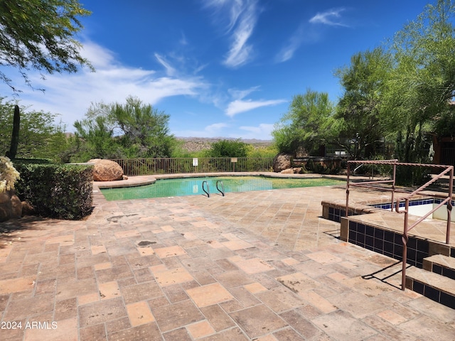 view of swimming pool with a patio area