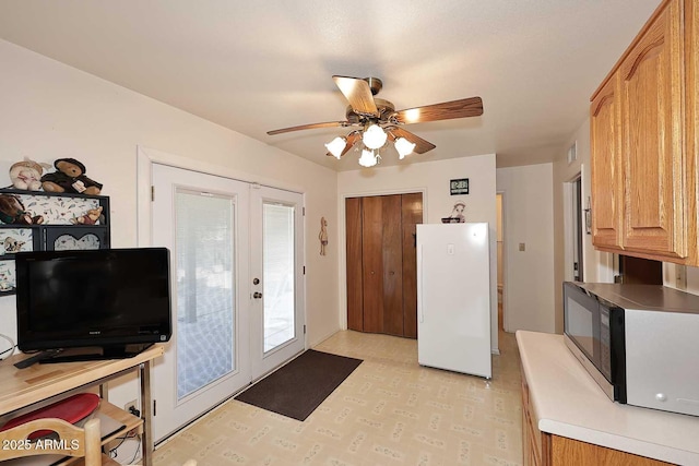 doorway to outside with ceiling fan and french doors