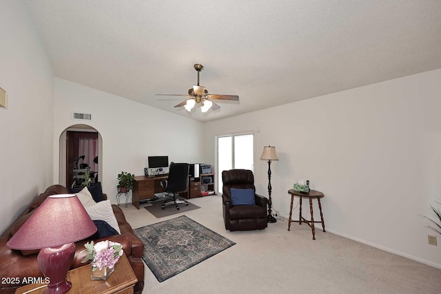 living room with ceiling fan, light colored carpet, a textured ceiling, and lofted ceiling