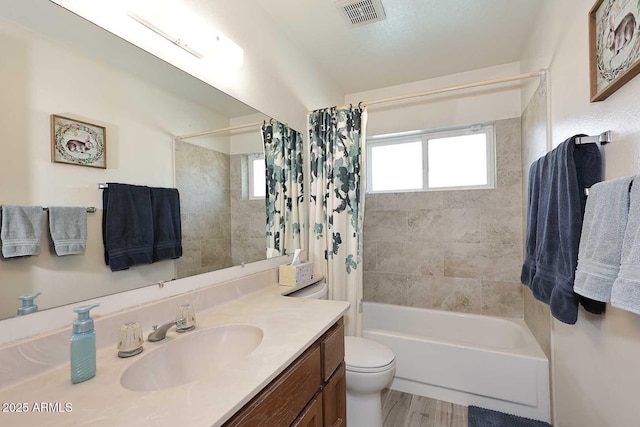 full bathroom with hardwood / wood-style flooring, toilet, vanity, and shower / tub combo with curtain