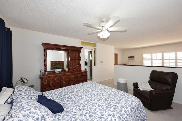 carpeted bedroom featuring ceiling fan and a textured ceiling