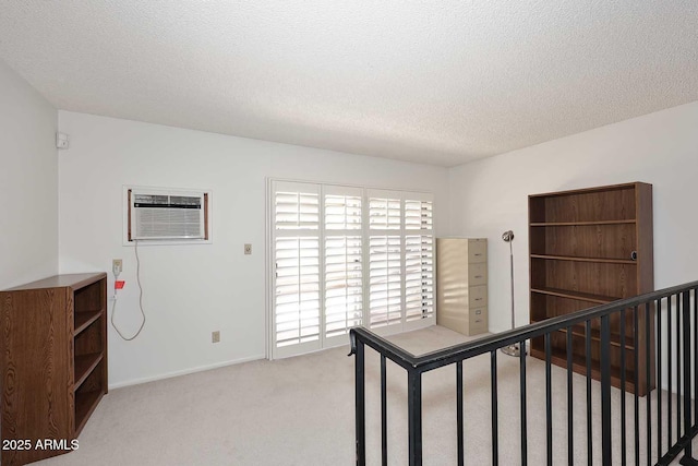 carpeted bedroom with a textured ceiling and a wall mounted AC