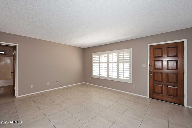 foyer featuring a textured ceiling and light tile patterned flooring