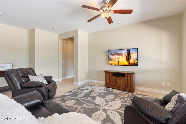 living room with ceiling fan and light hardwood / wood-style floors