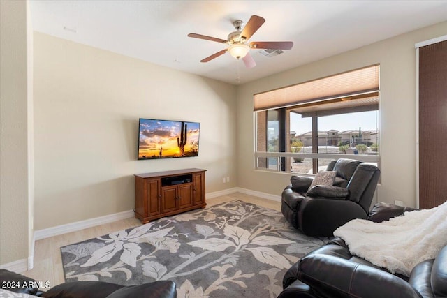 living room featuring light hardwood / wood-style floors and ceiling fan