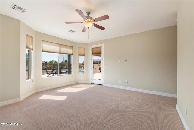 empty room featuring light carpet and ceiling fan