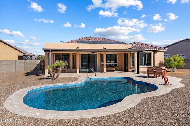view of swimming pool featuring a patio, a ceiling fan, a fenced in pool, and a fenced backyard