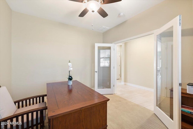 carpeted home office featuring ceiling fan and french doors