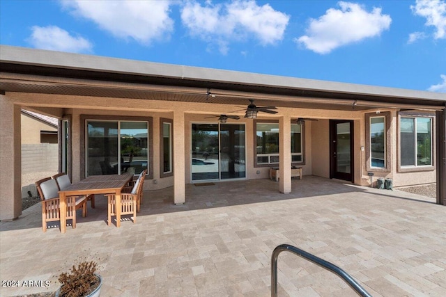 back of house with ceiling fan and a patio area