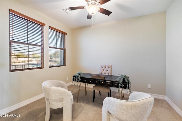 carpeted home office with visible vents, ceiling fan, and baseboards