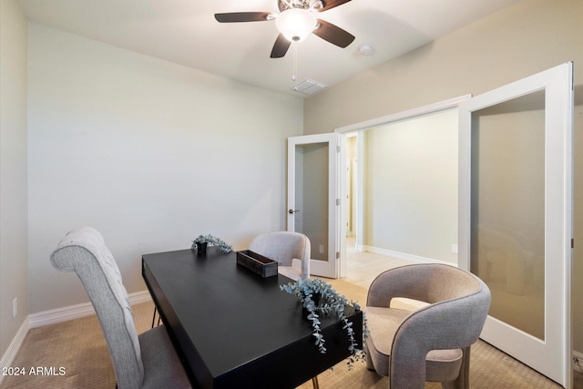office space with light colored carpet, baseboards, visible vents, a ceiling fan, and french doors