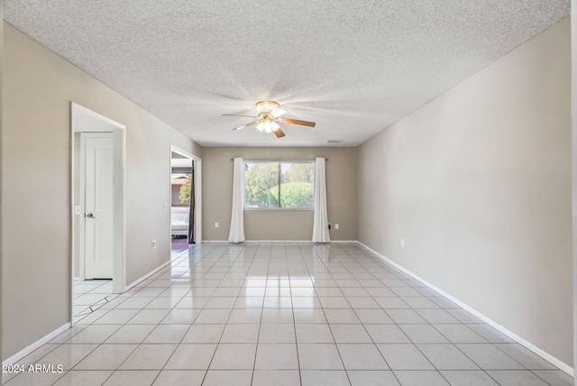 tiled spare room with ceiling fan and a textured ceiling