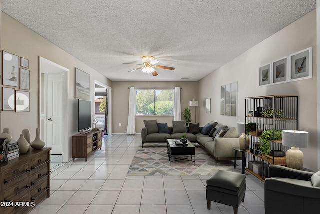 tiled living room featuring ceiling fan and a textured ceiling