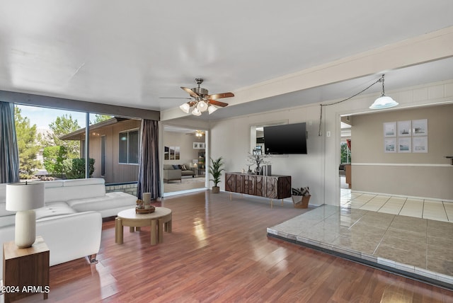 living room featuring hardwood / wood-style floors and ceiling fan