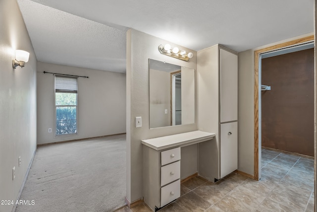 bathroom with vanity and a textured ceiling