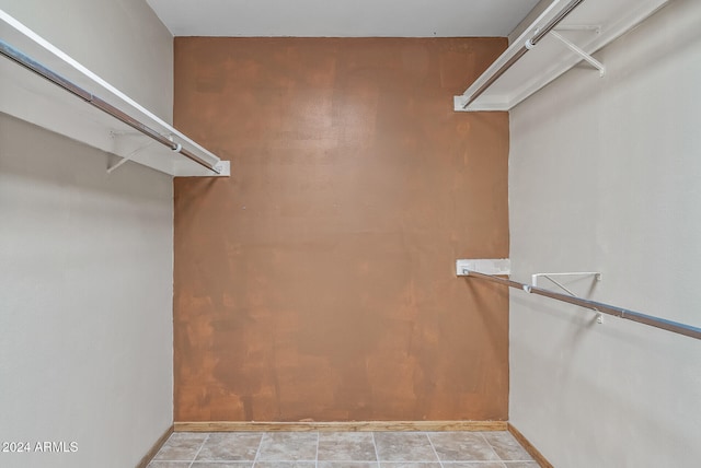 spacious closet featuring light tile patterned floors