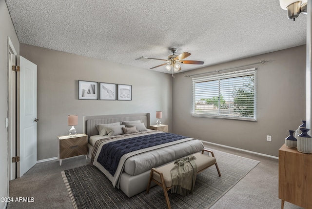 bedroom featuring carpet, ceiling fan, and a textured ceiling