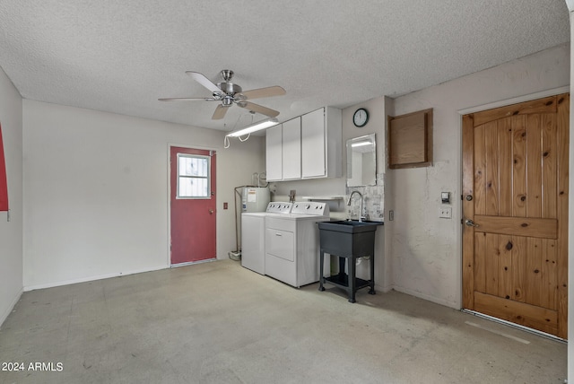 washroom featuring washing machine and clothes dryer, ceiling fan, cabinets, and a textured ceiling