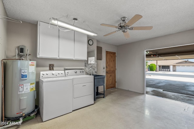 laundry area with cabinets, electric water heater, ceiling fan, a textured ceiling, and washing machine and clothes dryer