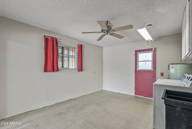 washroom with independent washer and dryer, a textured ceiling, a wealth of natural light, and water heater