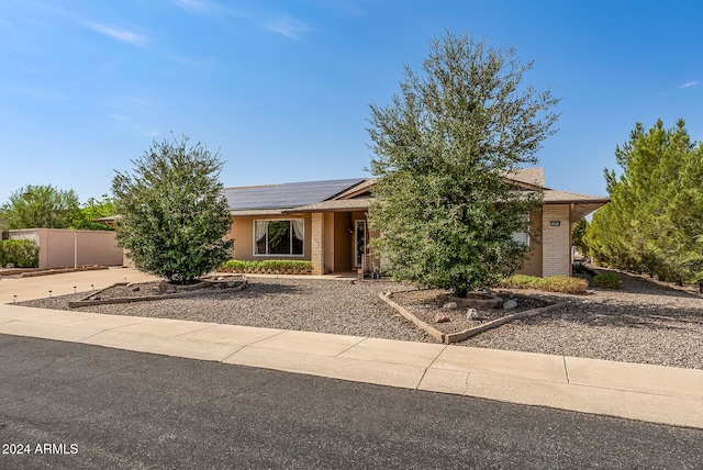 view of front of home featuring solar panels