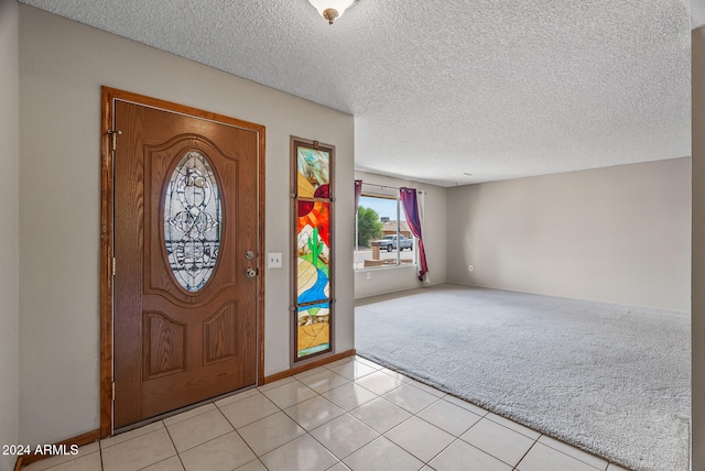 tiled entryway featuring a textured ceiling