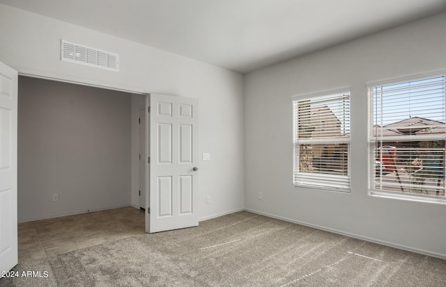 unfurnished bedroom with light carpet