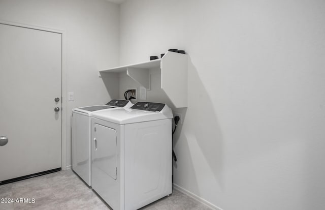 washroom with washing machine and clothes dryer