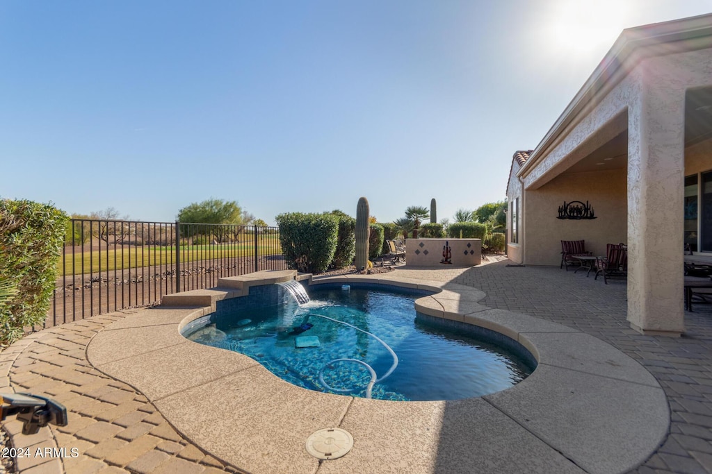 view of swimming pool featuring a patio and pool water feature