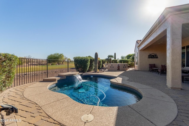 view of swimming pool featuring a patio and pool water feature