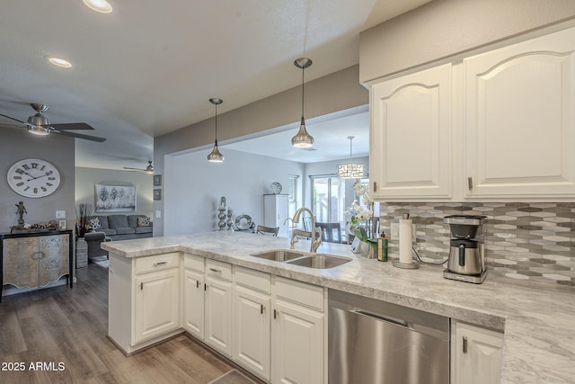 kitchen featuring sink, white cabinets, kitchen peninsula, and dishwasher