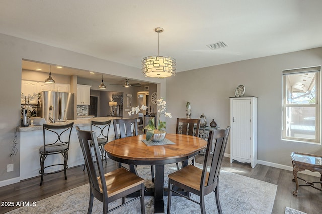 dining area with dark wood-type flooring