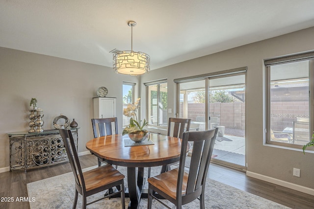 dining area with dark wood-type flooring