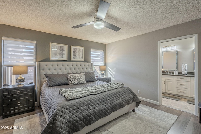 bedroom featuring wood-type flooring, connected bathroom, ceiling fan, and a textured ceiling