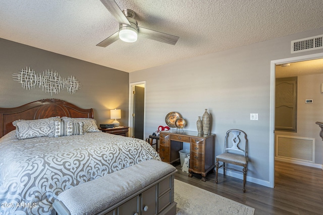 bedroom featuring ceiling fan, dark hardwood / wood-style flooring, and a textured ceiling