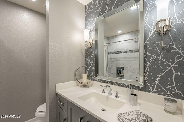 bathroom featuring walk in shower, vanity, and toilet