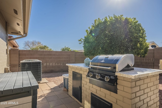 view of patio with central AC, area for grilling, and grilling area