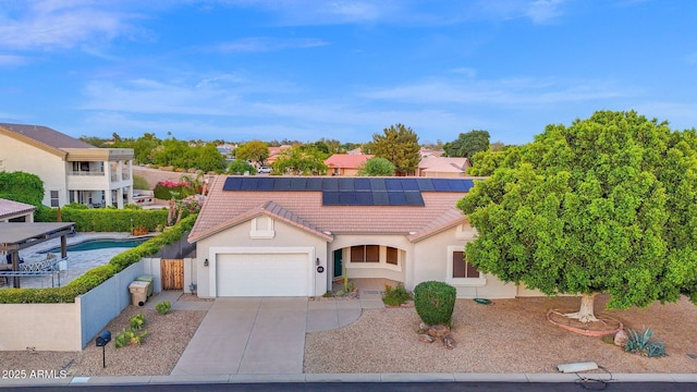 18161 N 63rd Ln, Glendale, AZ 85308 - view of front of home featuring driveway, a garage, stucco siding, roof mounted solar panels, and a tiled roof