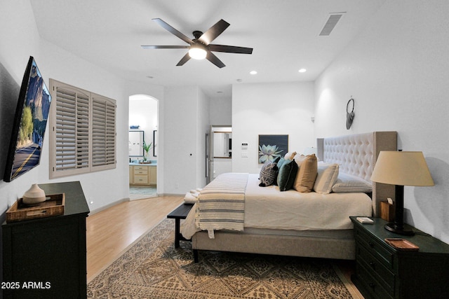 18161 N 63rd Ln, Glendale, AZ 85308 - bedroom featuring a ceiling fan, recessed lighting, ensuite bathroom, wood finished floors, and arched walkways